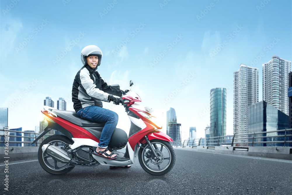 Asian motorcycle taxi man with his motorcycle on the asphalt road Asian motorcycle taxi man with his motorcycle on the asphalt road