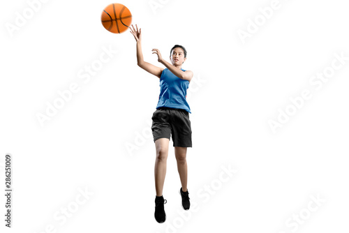 Asian woman basketball player in action with the ball © Leo Lintang