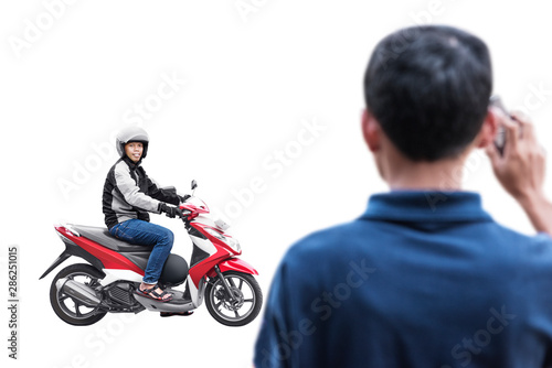 Asian motorcycle taxi man pick up his passenger