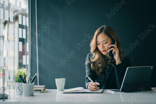 Portrait of beautiful smiling young  entrepreneur businesswoman working in modern work station. photo