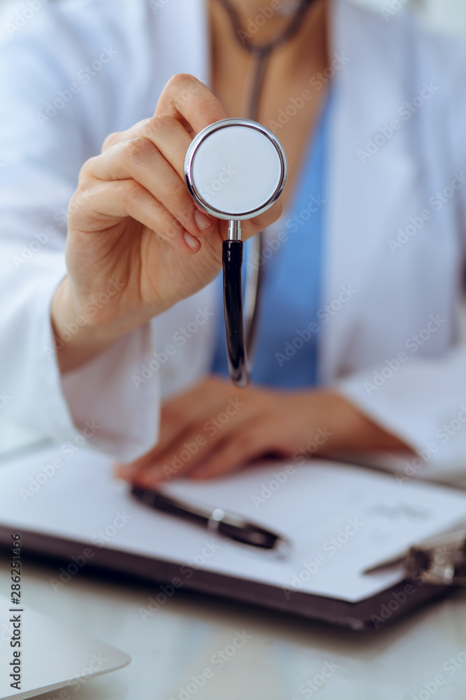 Doctor with a stethoscope in the hands, close up. Physician ready to examine and help patient. Medicine, healthcare and help concept