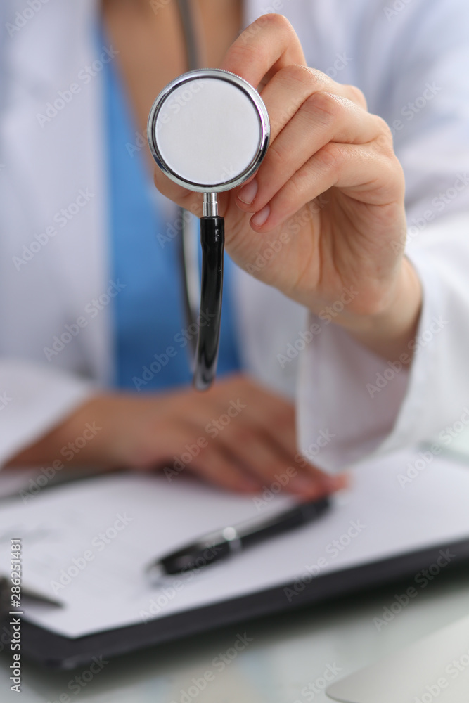 Doctor with a stethoscope in the hands, close up. Physician ready to examine and help patient. Medicine, healthcare and help concept Doctor with a stethoscope in the hands, close up. Physician ready to examine and help patient. Medicine, healthcare and help concept