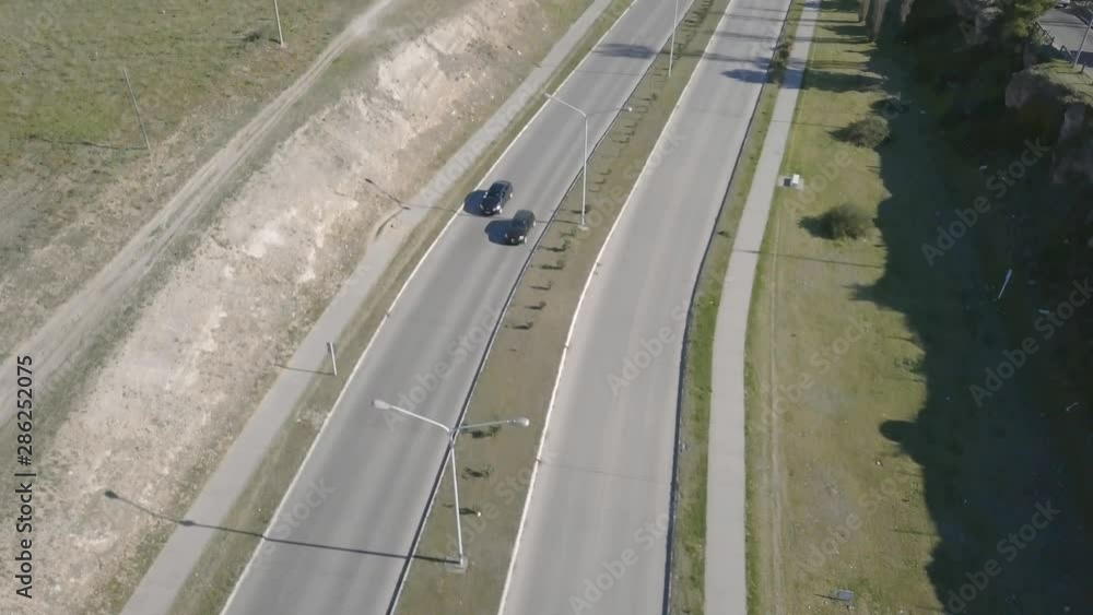 Aerial Drone shot tilting up of highway with city in the background, in Bahía Blanca, Argentina Aerial Drone shot tilting up of highway with city in the background, in Bahía Blanca, Argentina