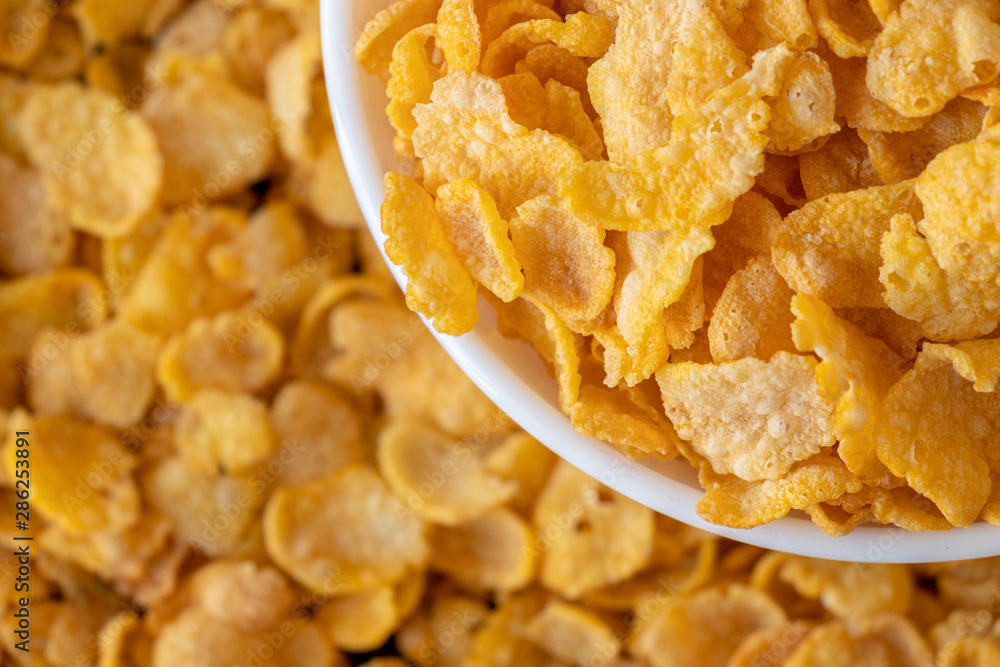 Cornflakes in blowl, a delicious and healthy dietary breakfast cereal. Selective Focus. Top View. Cornflakes in blowl, a delicious and healthy dietary breakfast cereal. Selective Focus. Top View.