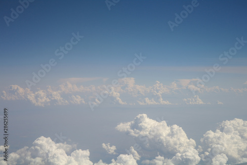 Obraz na płótnie clouds and blue sky seen from plane w salonie