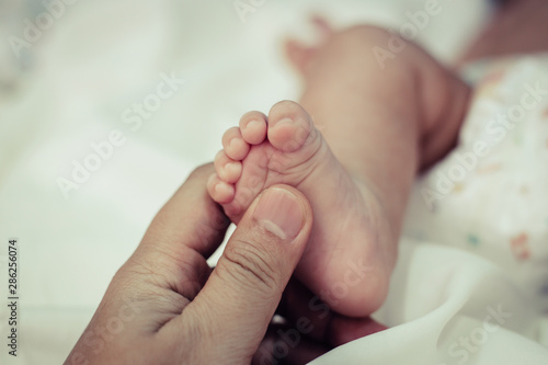 New born baby foot,selective focus © Johnstocker