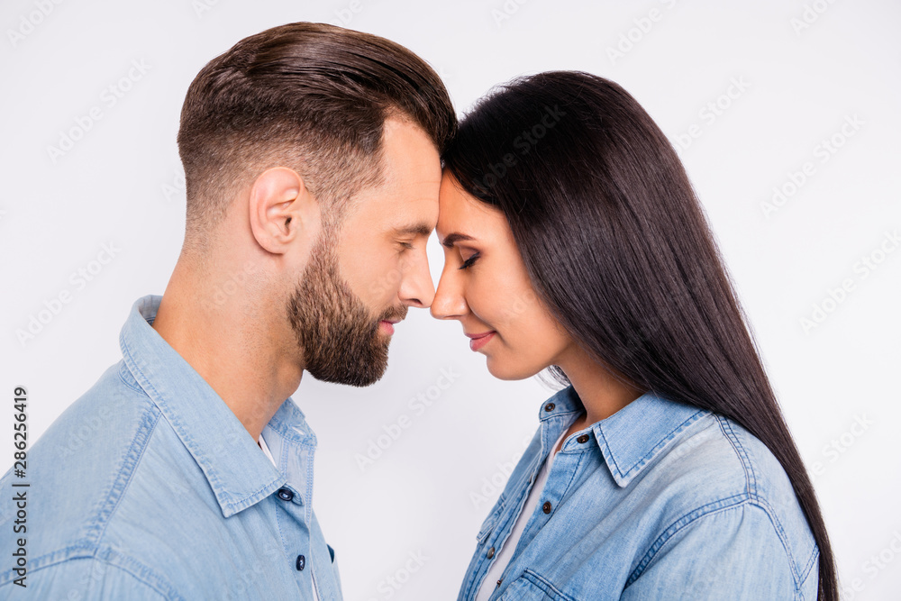 Profile side photo of charming people with their eyes closed wearing denim jeans shirt isolated over white background Profile side photo of charming people with their eyes closed wearing denim jeans shirt isolated over white background