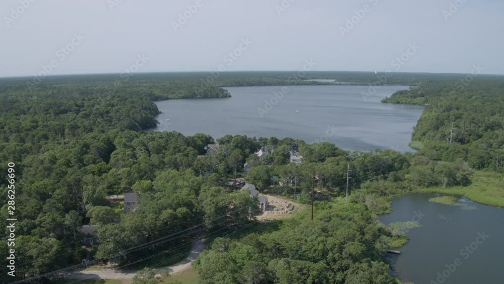 Aerial flyover vacation houses and a pond in Cape Cod Massachusetts Aerial flyover vacation houses and a pond in Cape Cod Massachusetts