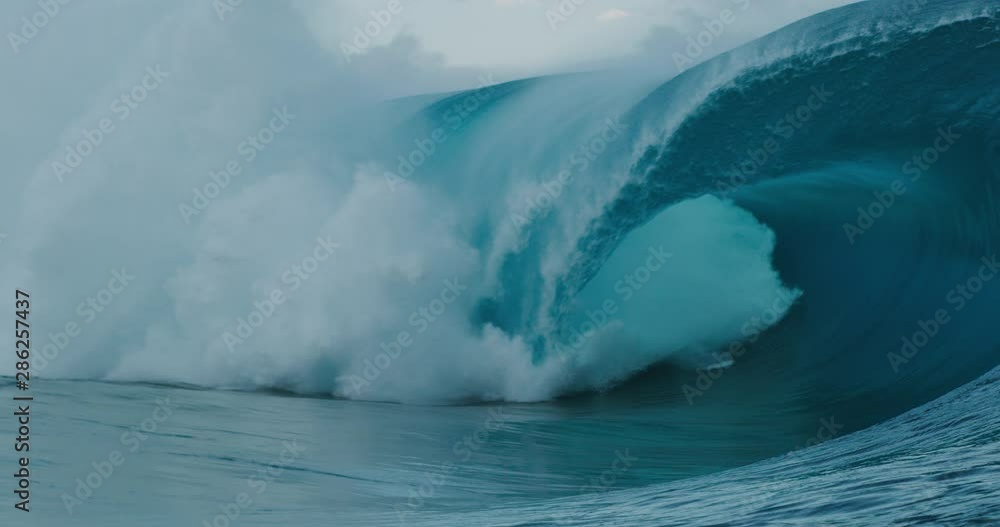 SUPER SLOW MOTION: Giant blue ocean wave breaking and barreling with spray SUPER SLOW MOTION: Giant blue ocean wave breaking and barreling with spray