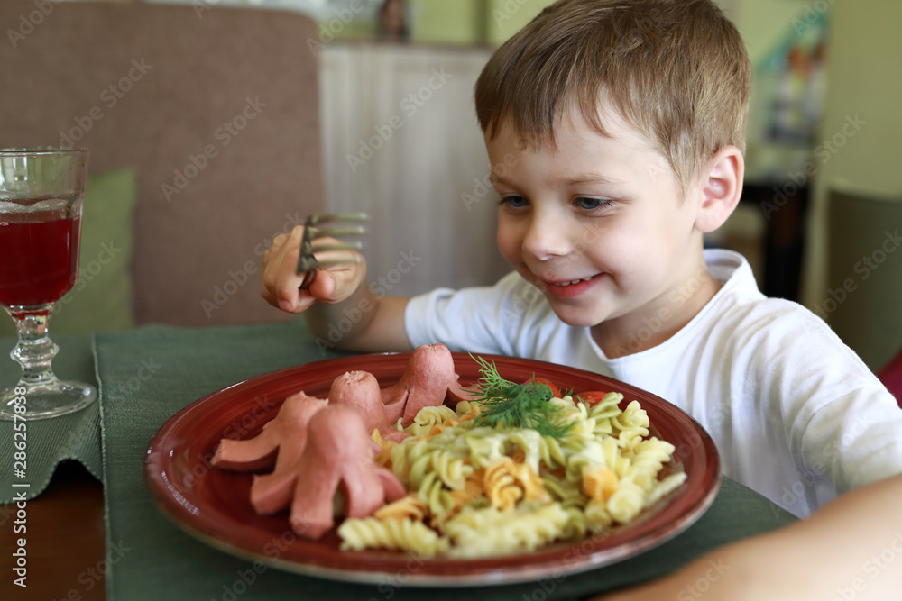 Child eating octopus sausages