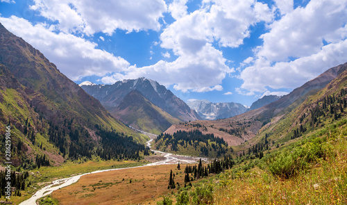 Panoramic view of the beautiful Left Talgar mountain valley with river, rocks and forest in Tian Shan mountains near Almaty city; best place for active lifestyle, hiking and trekking in Kazakhstan.