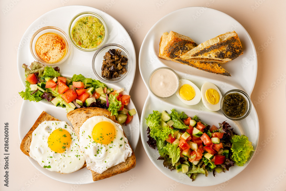 Two healthy breakfast with fried eggs and sauce Two healthy breakfast with fried eggs and sauce