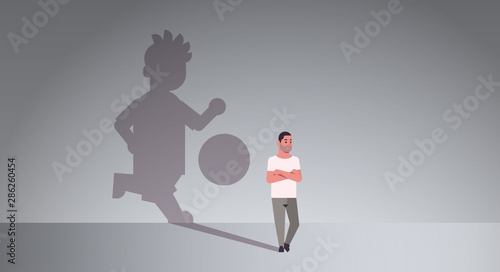 casual man dreaming about playing football guy and shadow of player with ball imagination aspiration concept male cartoon character standing pose full length flat horizontal