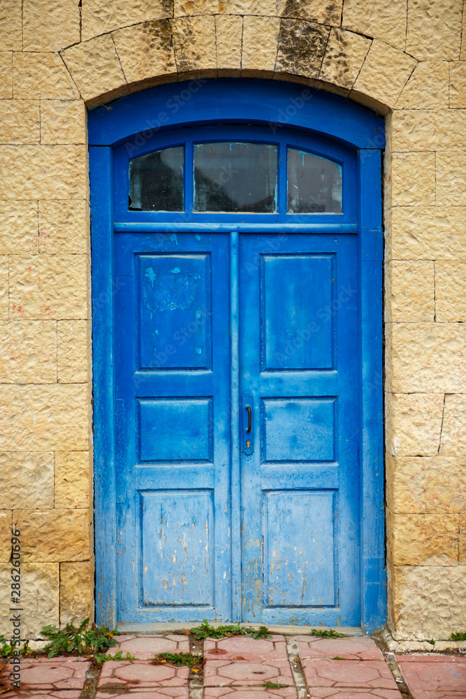 Photo of facade of old building with blue doors