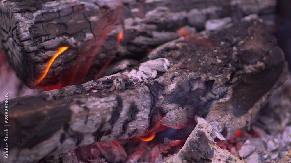Close-up of burning coals in the barbecue grill. Coal is starting to burn. Hot coal and flame with smoke. Close-up of burning coals in the barbecue grill. Coal is starting to burn. Hot coal and flame with smoke.