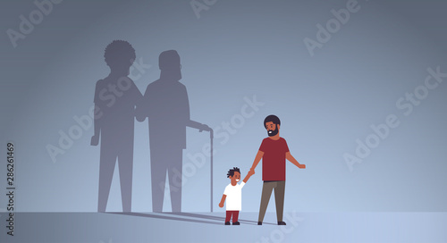 african american father with son holding hands shadow of young and mature man standing together imagination aspiration concept full length flat horizontal