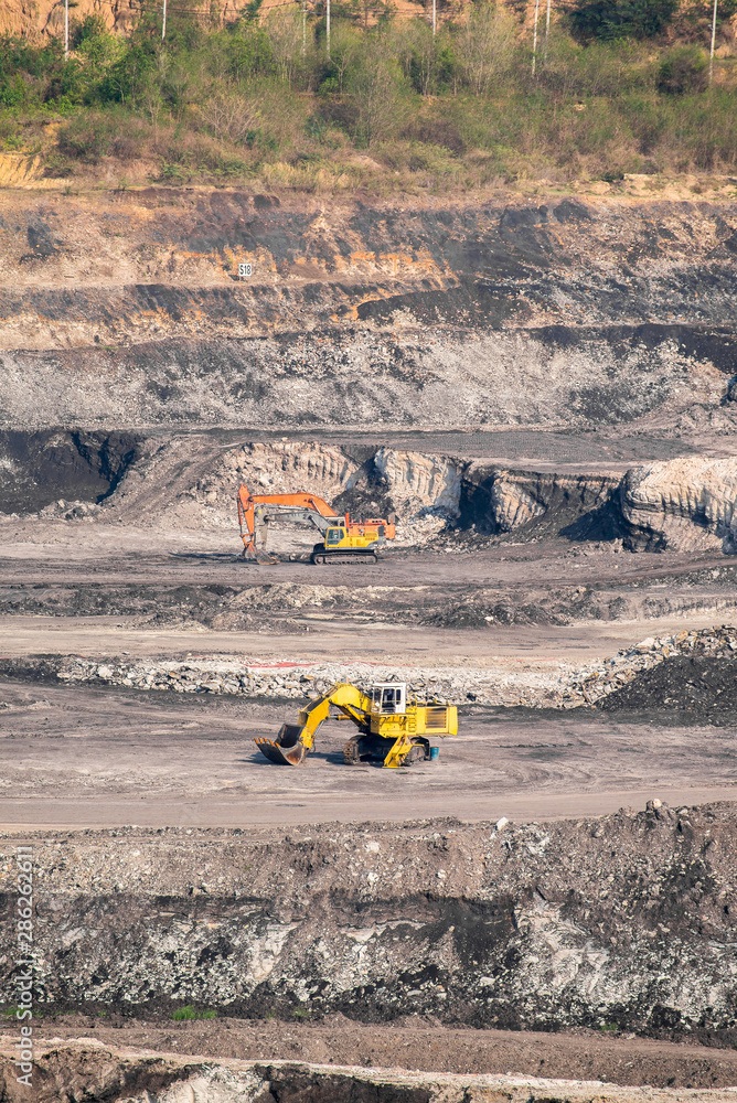 Part of a coal mine pit with big mining truck working Part of a coal mine pit with big mining truck working