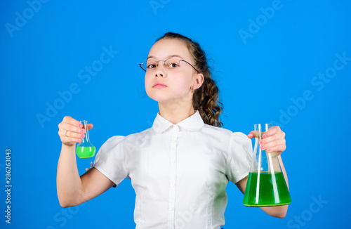 Knowledge day. Schoolgirl with chemical liquids. Childhood and upbringing. Knowledge and information. Experimenting a bit. Small kid study. Education concept. Chemistry fun. Basic knowledge