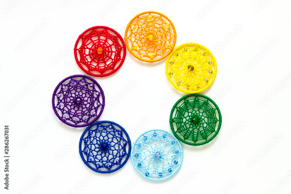 Handmade dream catcher with feathers threads and beads rope hanging on white background