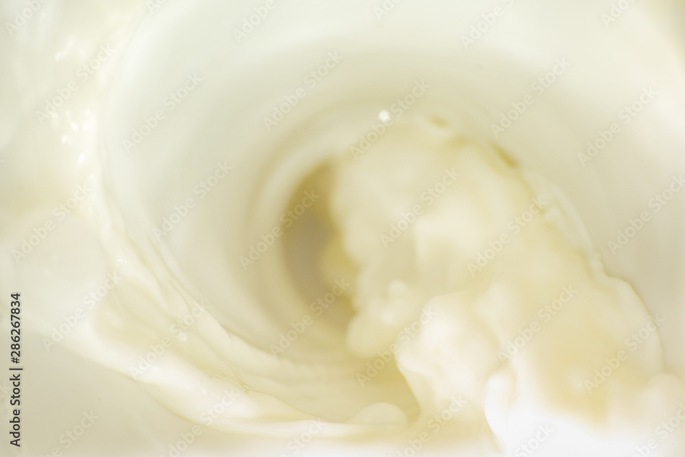 Background with flowing white milk, soft focus Background with flowing white milk, soft focus