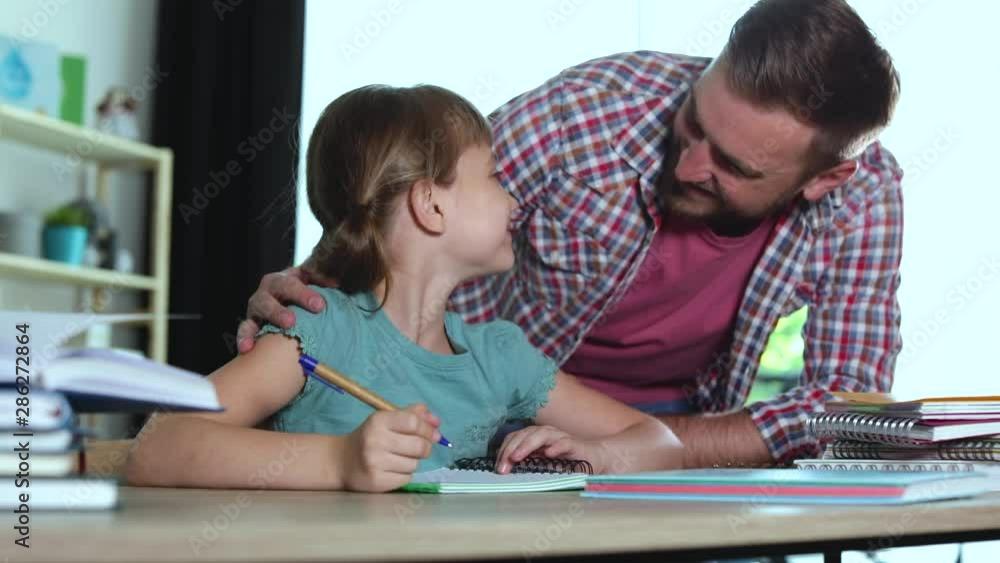 Dad checking daughter's homework assignment and taking her for break Dad checking daughter's homework assignment and taking her for break