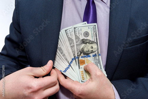 Male hands with dollar banknotes in pocket