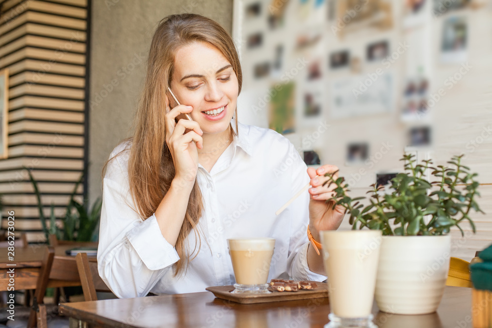 Business woman with smartphone working in open office place Business woman with smartphone working in open office place