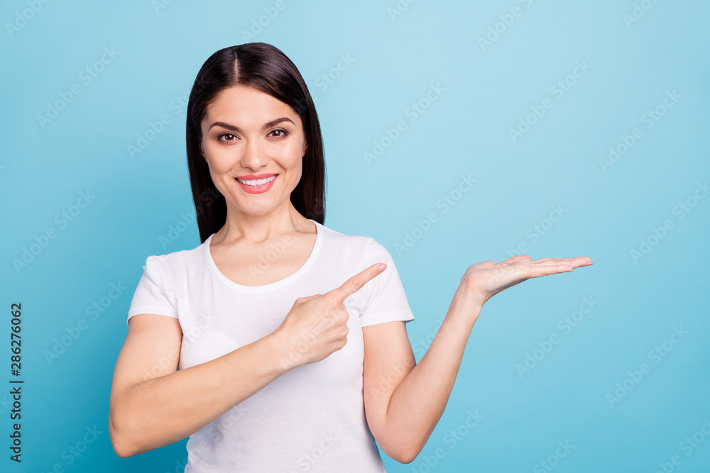 Photo of charming beautiful attractive nice cute glad girl pointing at your best choice while isolated with blue background Photo of charming beautiful attractive nice cute glad girl pointing at your best choice while isolated with blue background