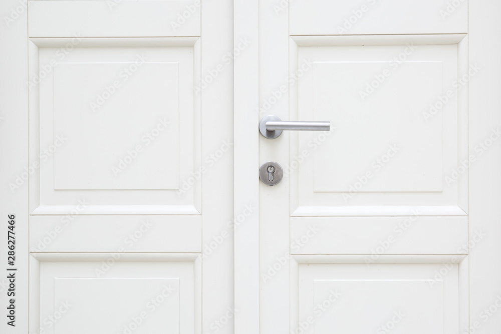 Fototapeta premium Silver aluminium modern metal handle on a white wooden door