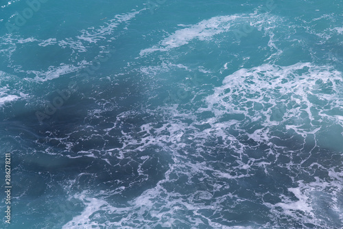 Sea surface. Blue background. Azure sea. Azure and turquoise backgrond. Marine waves.