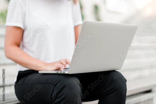 woman with laptop outdoors