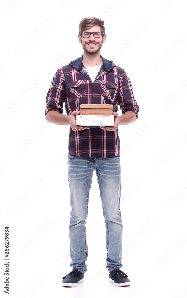 in full growth. smiling male student with books in full growth. smiling male student with books