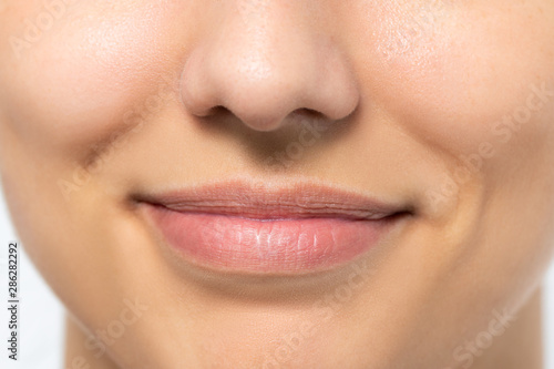 Macro detail of woman with charming smile.