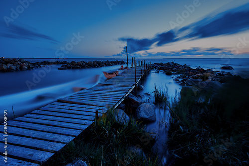 long eposure ocean wooden pier nigt time photo