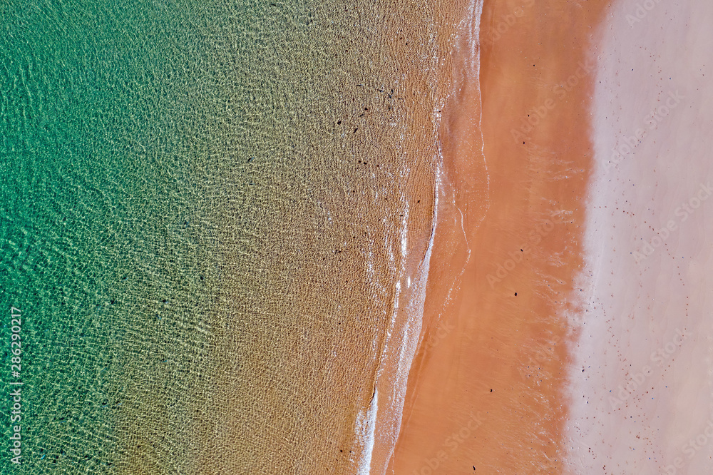 Aerial top shot from ocean waves at the beach Aerial top shot from ocean waves at the beach