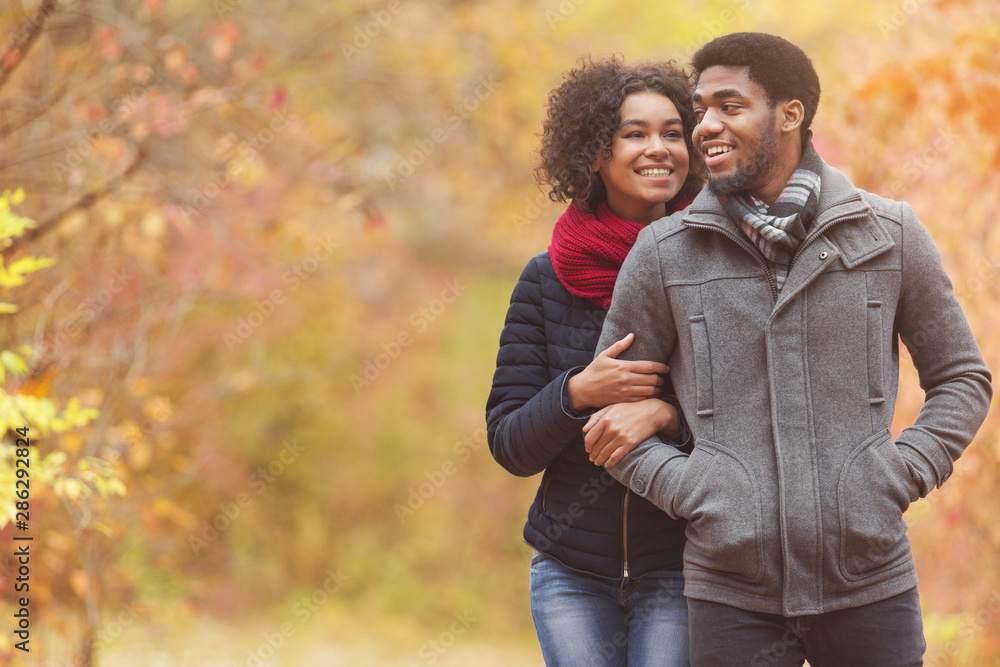 Loving afro couple dating in park, enjoying autumn day Loving afro couple dating in park, enjoying autumn day