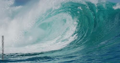 Slow motion barreling wave with texture and wind spray, raw natural wonders