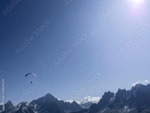 One Parachoutte in the blue sky with clouds in the French Alps  Chamonix during a summer tour  fly and sport.