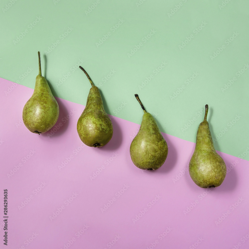 Fresh pears on pink and green background. Food minimal concept, delicious fruit Fresh pears on pink and green background. Food minimal concept, delicious fruit