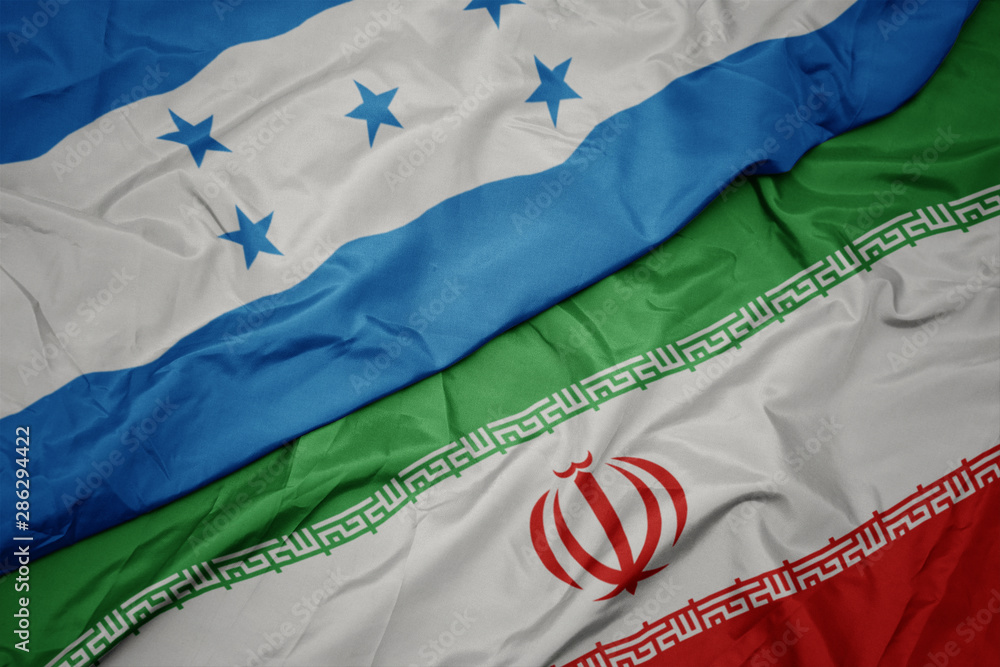 waving colorful flag of iran and national flag of honduras.