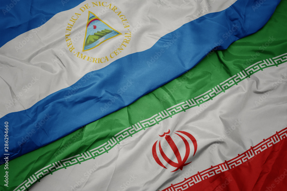waving colorful flag of iran and national flag of nicaragua.