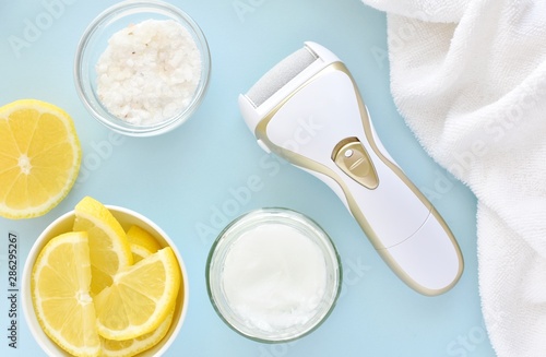 Foot care with natural products, lemon, salt and coconut oil, electric feet file to remove hard skin, top view