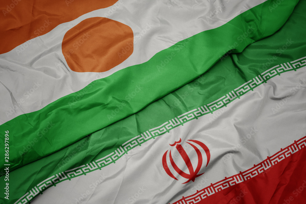 waving colorful flag of iran and national flag of niger.