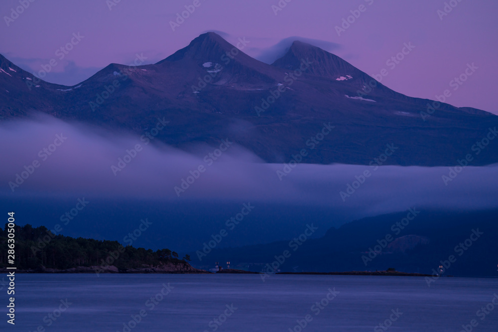 Landscape of mountains coming out from the sea in Molde, a beautiful view from of the fjord.
