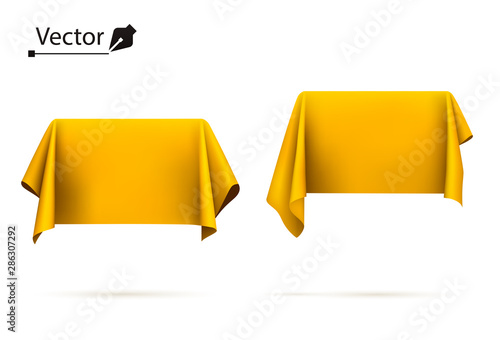 Object covered with golden silk cloth. Box, rectangle. Surprise, award, prize, presentation concept. Reveal a hidden object. 