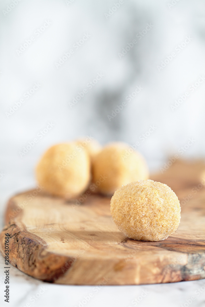 Keto pumpkin pie fat bombs. Made with pumpkin, coconut oil and other fats then coated with erythritol sugar substitue. .Selective focus with blurred background. Ketogenic diet concept . Keto pumpkin pie fat bombs. Made with pumpkin, coconut oil and other fats then coated with erythritol sugar substitue. .Selective focus with blurred background. Ketogenic diet concept .