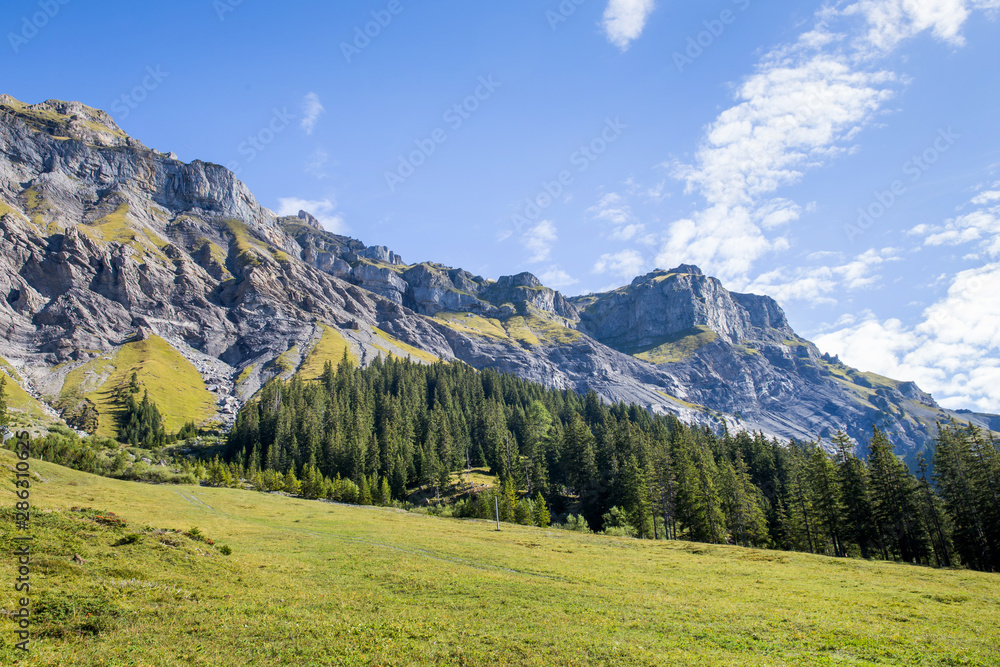 Backpack and mountain panorama. Swiss Alps