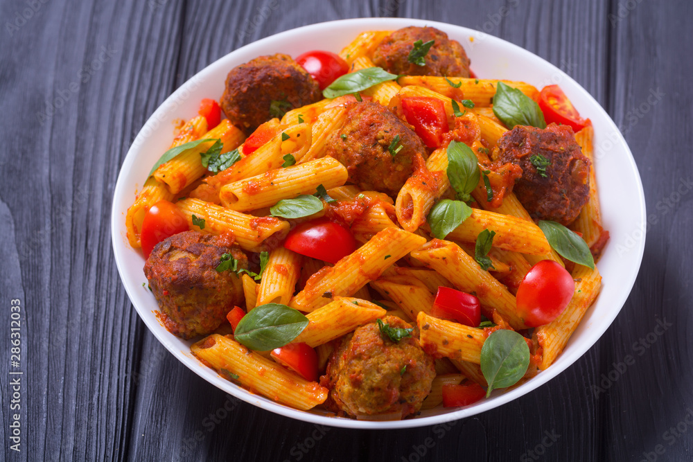 Italian penne pasta with meatballs and tomatoes Italian penne pasta with meatballs and tomatoes