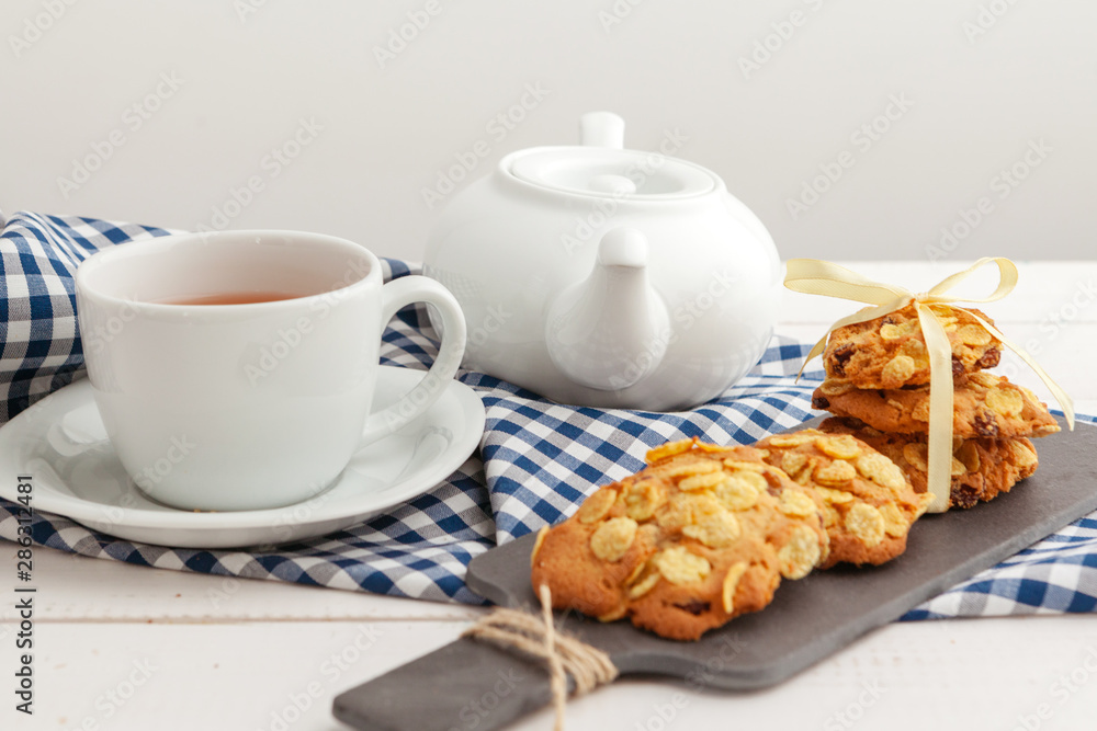Homemade crunchy cookies and tea on a wooden table Homemade crunchy cookies and tea on a wooden table