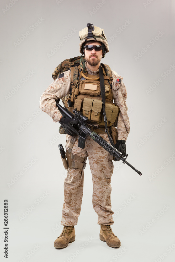 Portrait of a young American US Marine Corps soldier over grey background Portrait of a young American US Marine Corps soldier over grey background